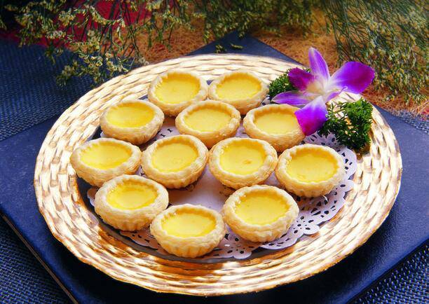 Picture of homemade original egg tarts in an oven