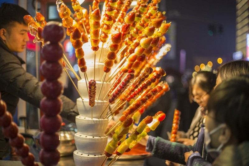 Sweet and sour old Beijing snack Tomatoes on sticks pictures