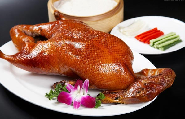 A group of pictures of a whole roasted duck that looks so tempting to eat
