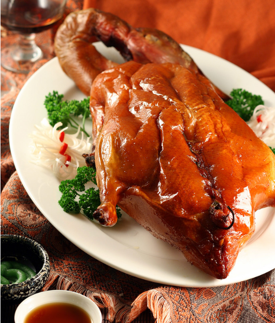 A group of pictures of a whole roasted duck that looks so tempting to eat