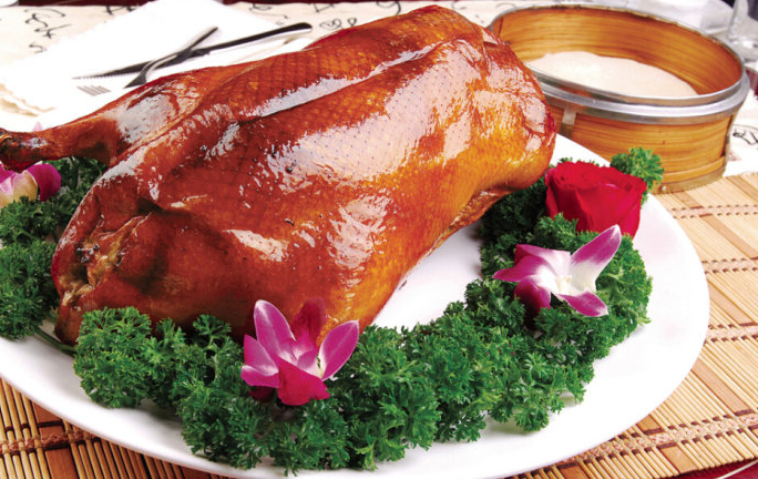 A group of pictures of a whole roasted duck that looks so tempting to eat