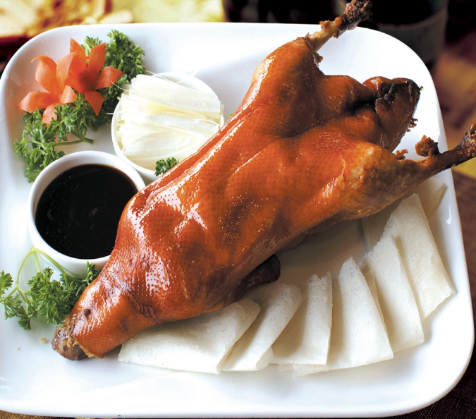 A group of pictures of a whole roasted duck that looks so tempting to eat