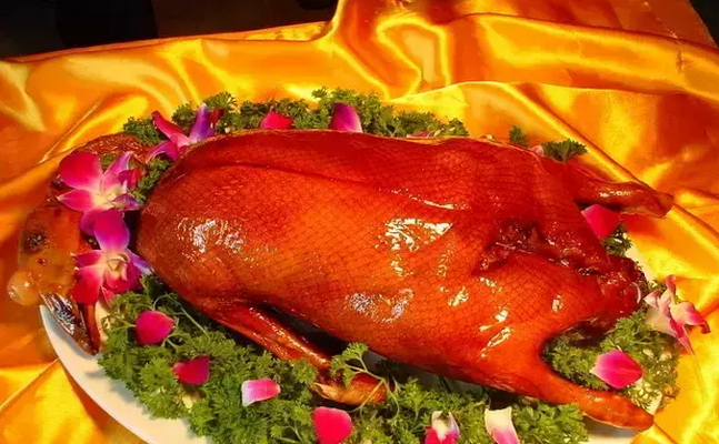 A group of pictures of a whole roasted duck that looks so tempting to eat