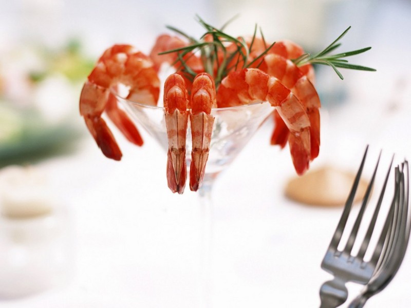 A collection of pictures of seafood delicacies on the dining table