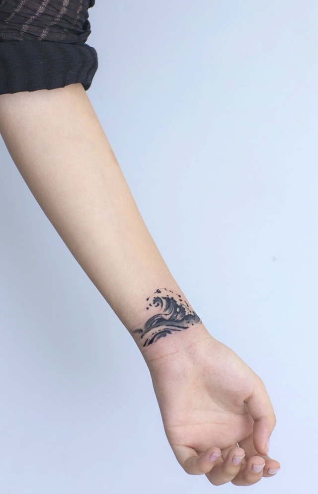 A personalized wave tattoo on a girl's arm