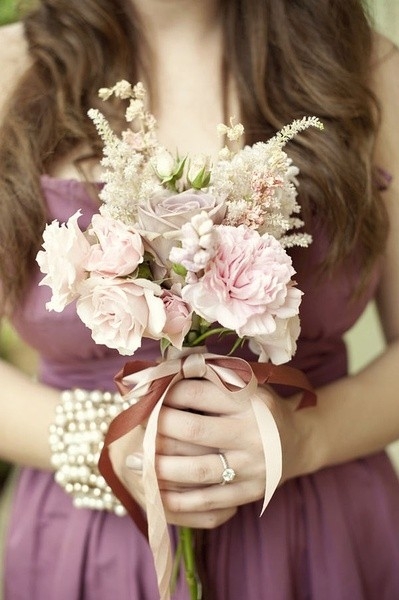 A beautiful picture of a girl holding flowers in front of you