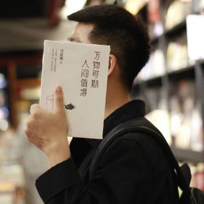 A picture of a man and a woman covering their faces and heads with books