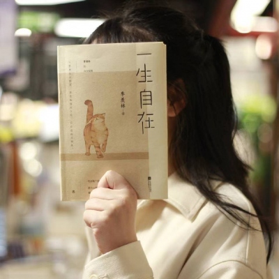 A picture of a man and a woman covering their faces and heads with books