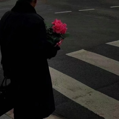 Male head holding flowers in hand