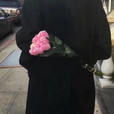 Male head holding flowers in hand