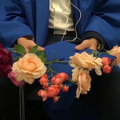 Male head holding flowers in hand