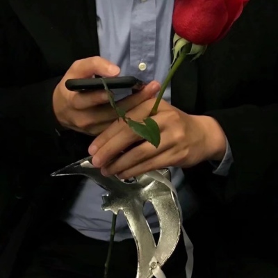 Male head holding flowers in hand