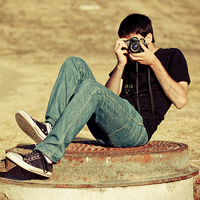 Good-looking boy taking a picture with camera