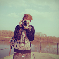 Good-looking boy taking a picture with camera