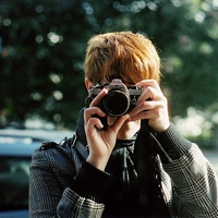 Good-looking boy taking a picture with camera