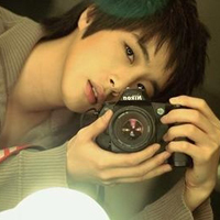 Good-looking boy taking a picture with camera