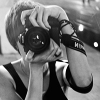 Good-looking boy taking a picture with camera