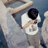 Good-looking boy taking a picture with camera