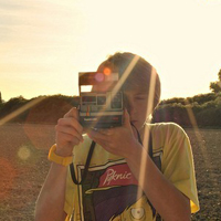 Good-looking boy taking a picture with camera