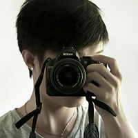 Good-looking boy taking a picture with camera