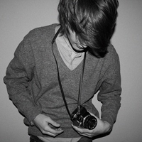 Good-looking boy taking a picture with camera