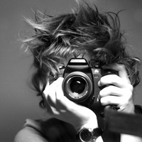 Good-looking boy taking a picture with camera