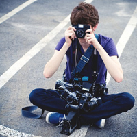 Good-looking boy taking a picture with camera