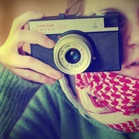 Good-looking boy taking a picture with camera