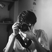 Good-looking boy taking a picture with camera