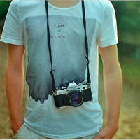 Good-looking boy taking a picture with camera