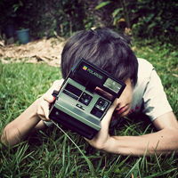 Good-looking boy taking a picture with camera