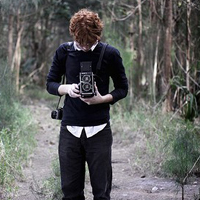 Good-looking boy taking a picture with camera