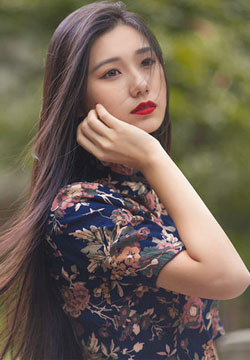 Fresh outdoor shot of beautiful woman with red lips and cheongsam