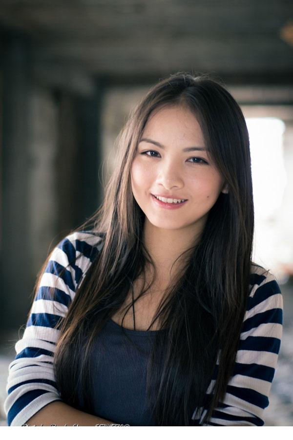 Charming street photo of sweet long-haired girl