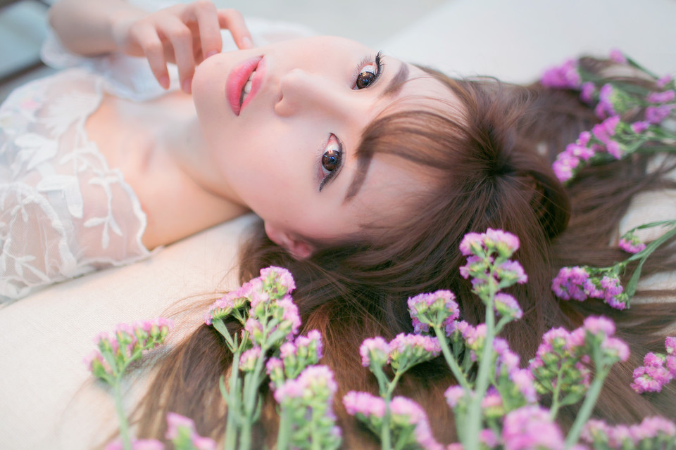 Beautiful portrait of the girl next door holding flowers